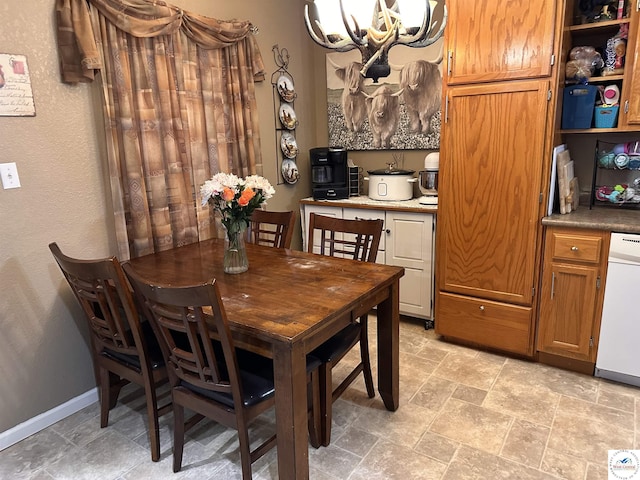 34443 Peters Ave, Warsaw, MO 65355 - dining area with stone finish floor, a chandelier, and baseboards