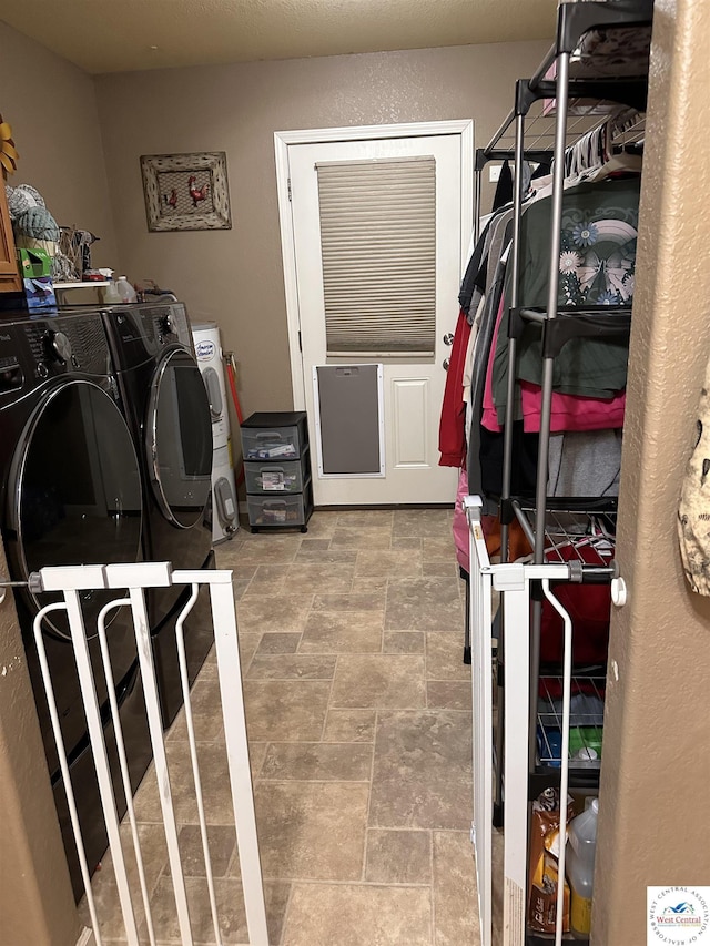 34443 Peters Ave, Warsaw, MO 65355 - laundry area with stone finish floor, washing machine and clothes dryer, and laundry area