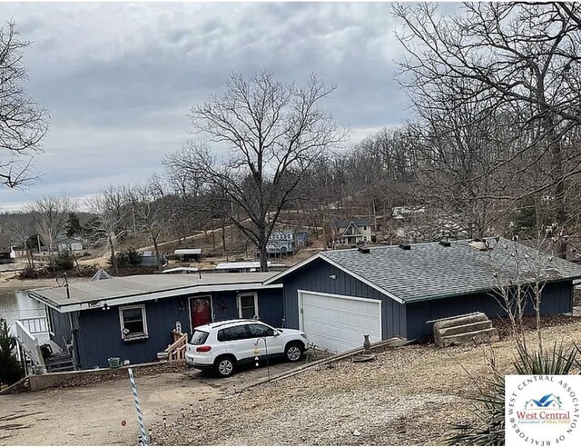 592 Woodland Dr, Climax Springs, MO 65324 - view of front facade with an attached garage, roof with shingles, and driveway