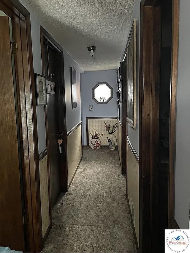 592 Woodland Dr, Climax Springs, MO 65324 - corridor with dark carpet and a textured ceiling