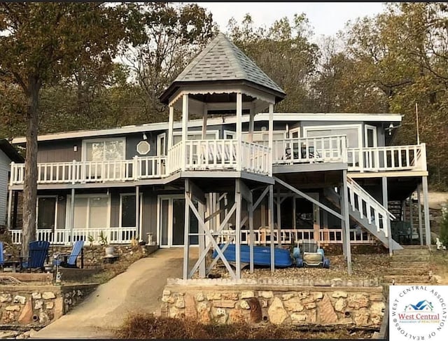 592 Woodland Dr, Climax Springs, MO 65324 - back of property featuring a wooden deck, stairs, and view of wooded area