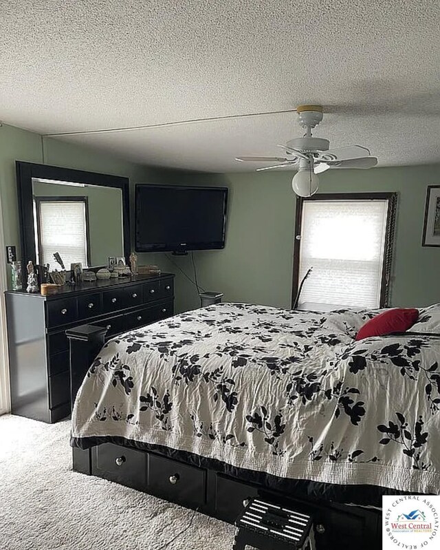 592 Woodland Dr, Climax Springs, MO 65324 - bedroom featuring a textured ceiling, carpet flooring, and a ceiling fan