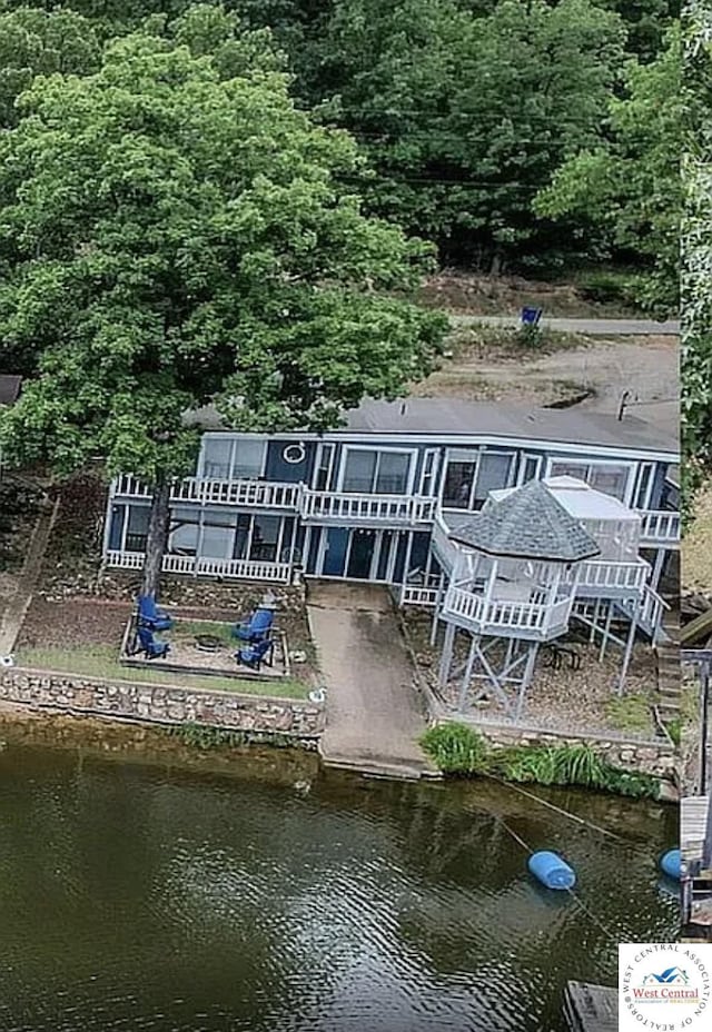 592 Woodland Dr, Climax Springs, MO 65324 - rear view of house with a water view and a wooded view