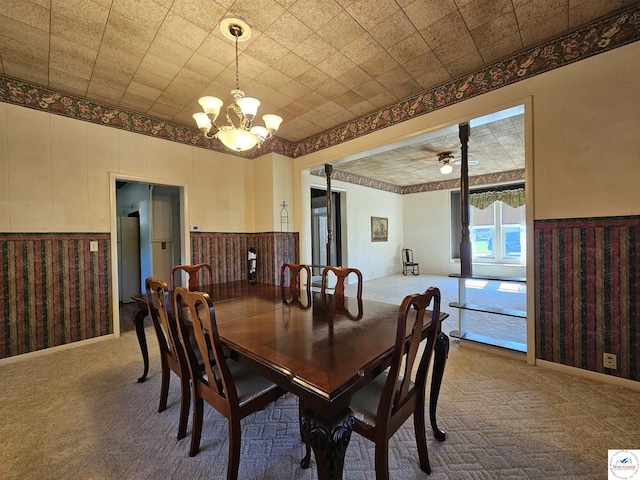 406 W Main St, Cole Camp, MO 65325 - carpeted dining room featuring a chandelier and a wainscoted wall