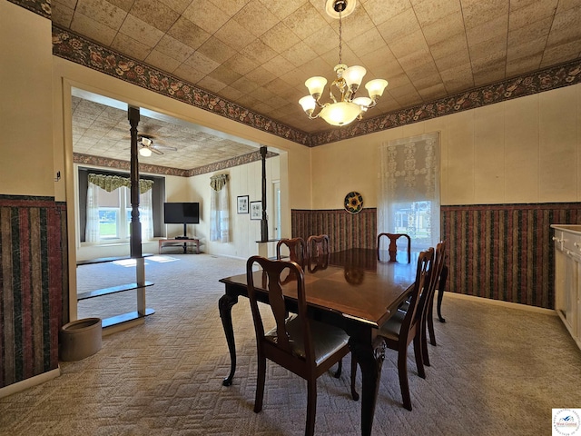 406 W Main St, Cole Camp, MO 65325 - carpeted dining area featuring a chandelier, a wainscoted wall, and wallpapered walls