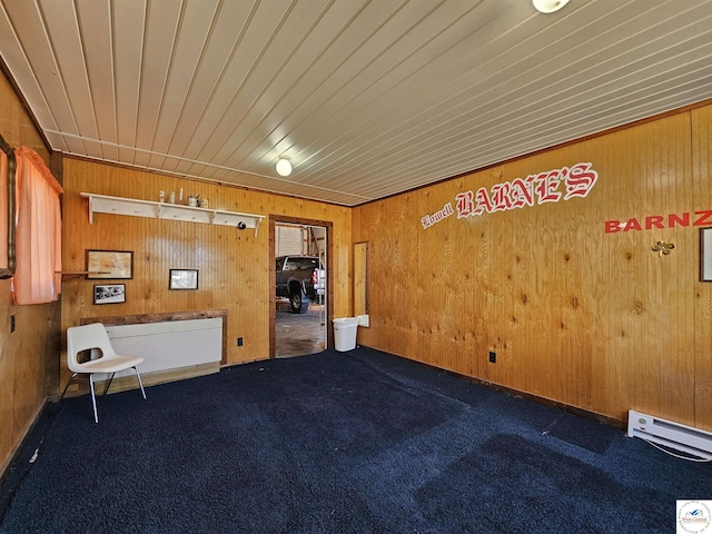 406 W Main St, Cole Camp, MO 65325 - carpeted spare room featuring wood walls, baseboard heating, and wood ceiling