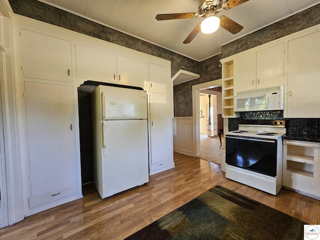 406 W Main St, Cole Camp, MO 65325 - kitchen featuring white appliances, wood finished floors, a ceiling fan, open shelves, and wainscoting