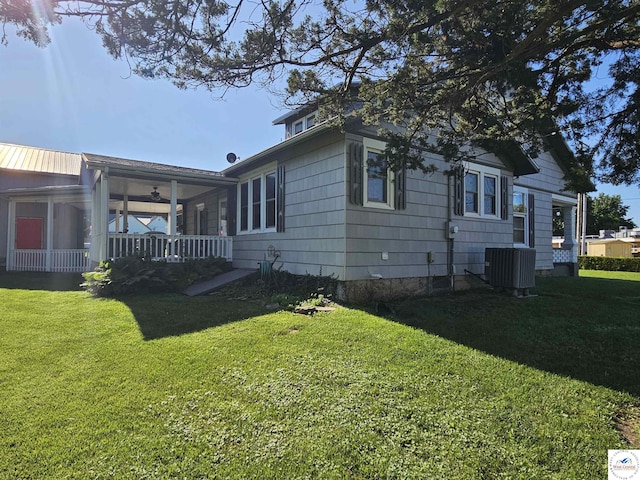 406 W Main St, Cole Camp, MO 65325 - view of side of home featuring a yard, covered porch, and ceiling fan