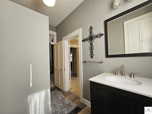 406 W Main St, Cole Camp, MO 65325 - bathroom featuring wood finished floors and vanity