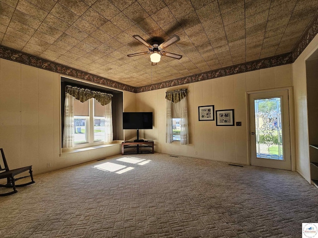 406 W Main St, Cole Camp, MO 65325 - unfurnished living room featuring carpet and a ceiling fan