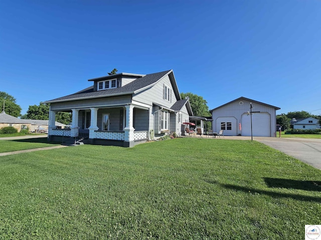 406 W Main St, Cole Camp, MO 65325 - view of front of home with a porch, a detached garage, an outdoor structure, and a front lawn