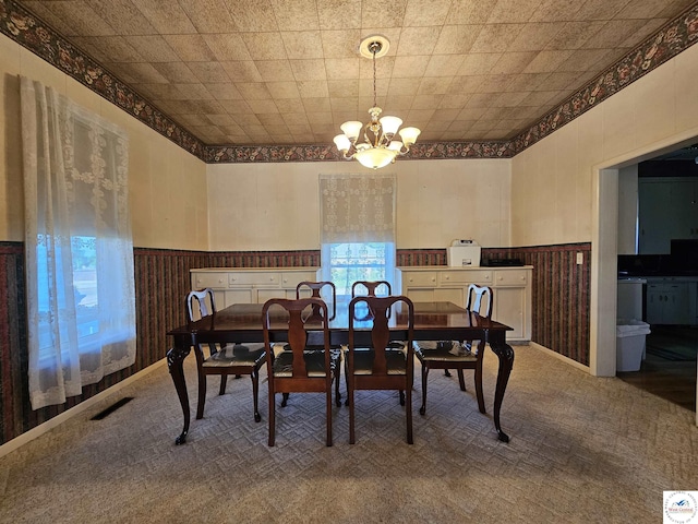 406 W Main St, Cole Camp, MO 65325 - dining room featuring a chandelier, wainscoting, and carpet floors