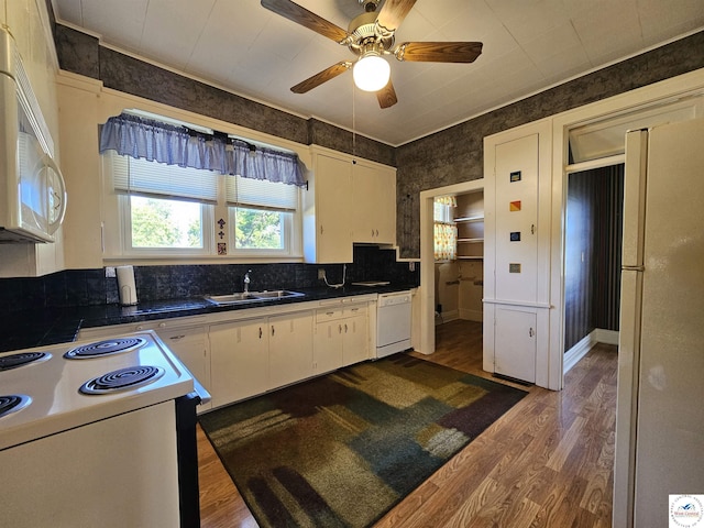 406 W Main St, Cole Camp, MO 65325 - kitchen featuring white appliances, dark wood finished floors, white cabinetry, ceiling fan, and dark countertops
