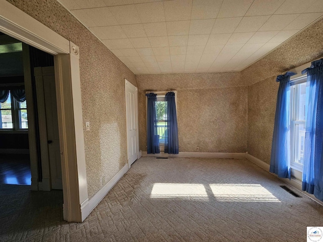 406 W Main St, Cole Camp, MO 65325 - carpeted spare room featuring wallpapered walls