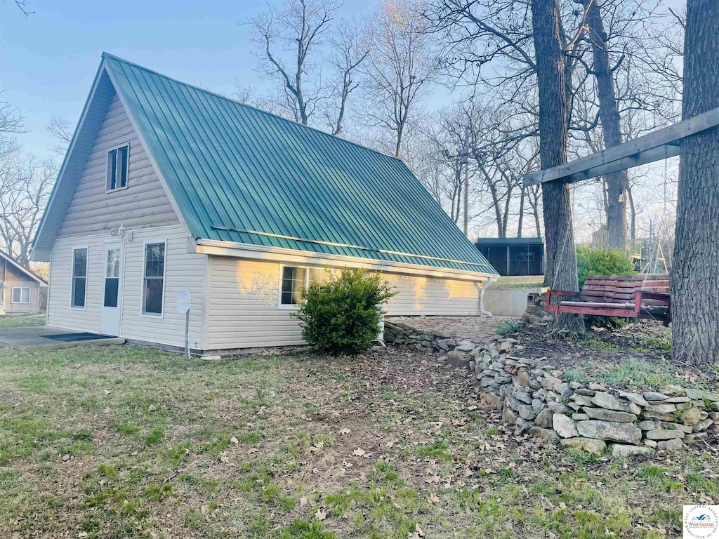 view of home's exterior featuring a standing seam roof and metal roof