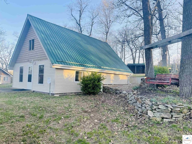 view of home's exterior featuring a standing seam roof and metal roof