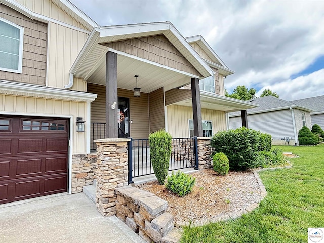 711 Katy Cir, Sedalia, MO 65301 - entrance to property featuring a porch, stone siding, and board and batten siding