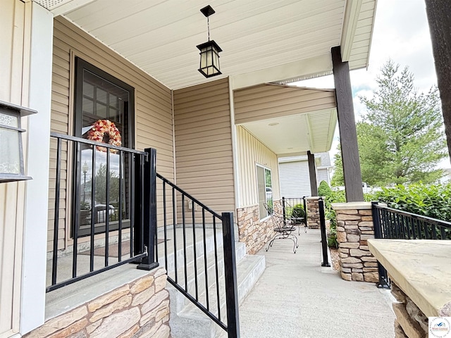 711 Katy Cir, Sedalia, MO 65301 - view of exterior entry with covered porch and stone siding