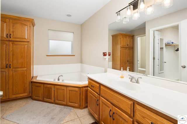 full bath featuring tile patterned floors, a garden tub, toilet, and vanity