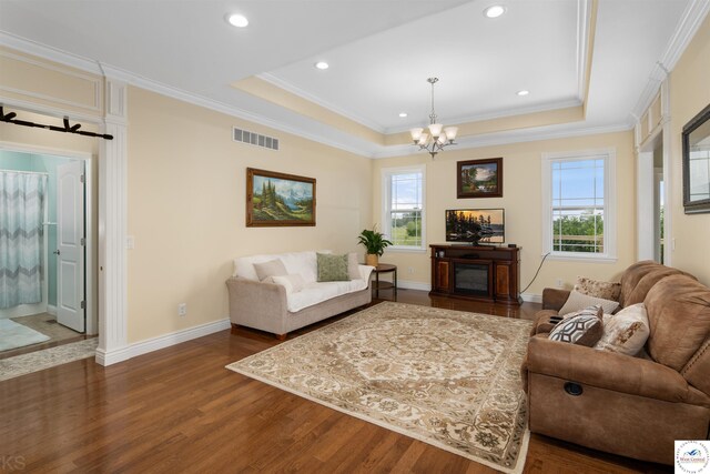 29854 Griessen Rd, Smithton, MO 65350 - living room featuring dark wood-type flooring, plenty of natural light, a chandelier, baseboards, and crown molding