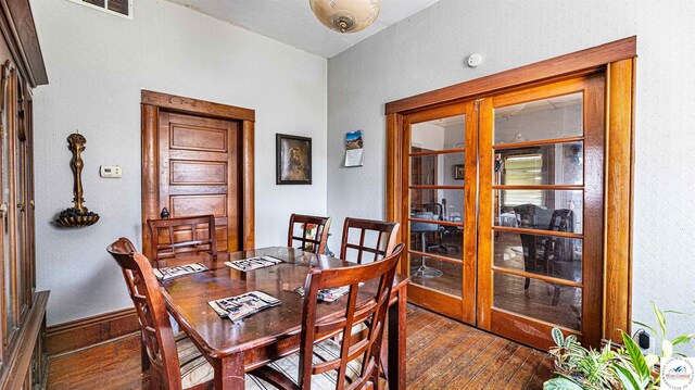 28302 S D State Rte, Cleveland, MO 64734 - dining room with wood-type flooring, visible vents, french doors, and baseboards