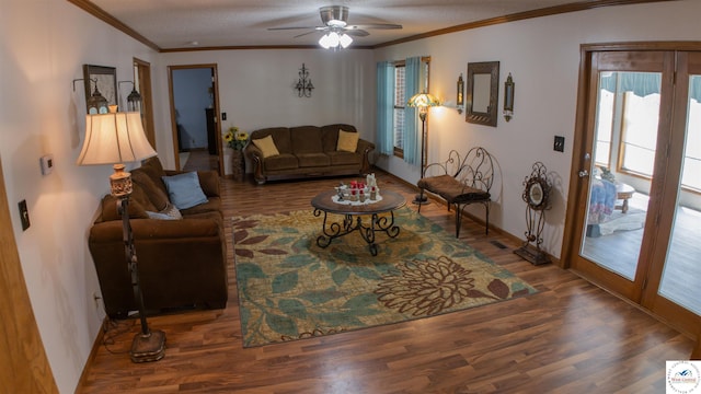 living area with baseboards, wood finished floors, a ceiling fan, and ornamental molding