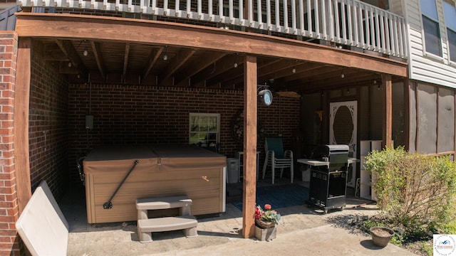 view of patio featuring a deck and a hot tub