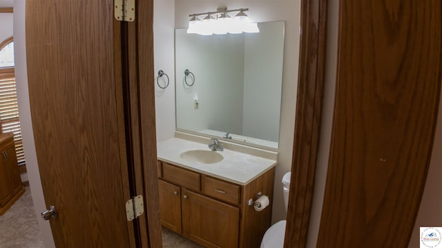 bathroom with toilet and vanity