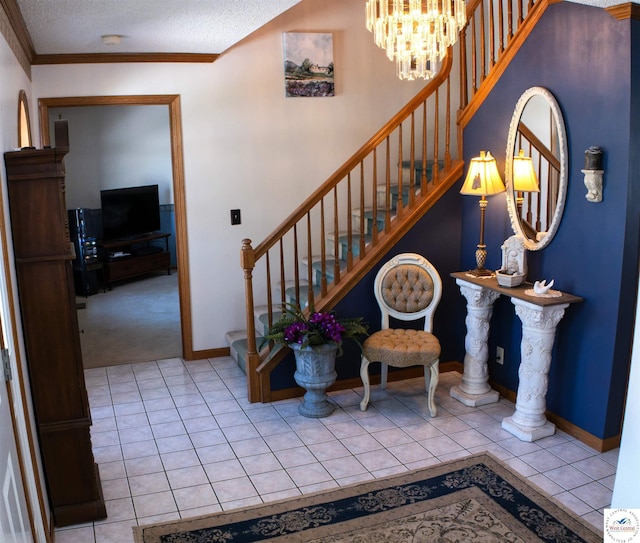 staircase featuring a textured ceiling, a chandelier, tile patterned floors, and baseboards