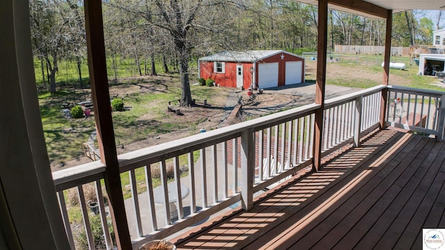 1679 Sunchase Dr, Warsaw, MO 65355 - deck featuring an outbuilding, aphalt driveway, and a detached garage