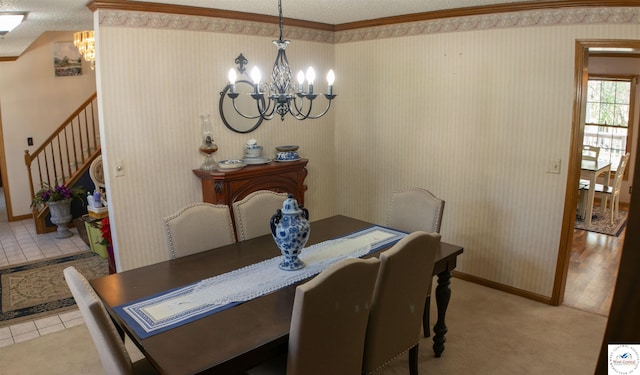 dining room featuring stairway, a chandelier, crown molding, and a textured ceiling