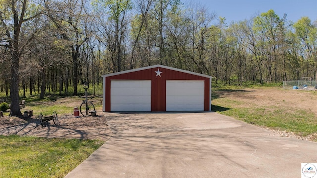 1679 Sunchase Dr, Warsaw, MO 65355 - detached garage featuring a view of trees