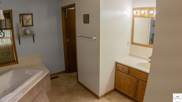 bathroom featuring a bath, visible vents, vanity, and baseboards
