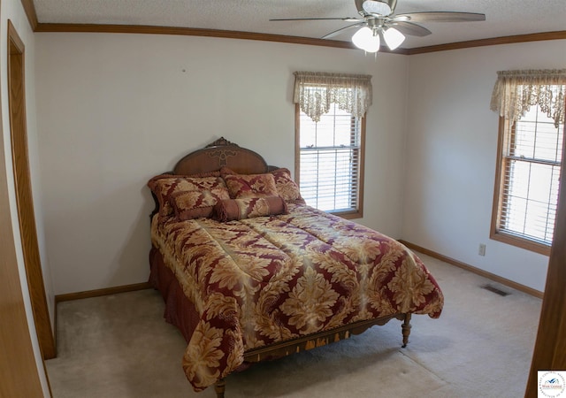 bedroom featuring visible vents, a textured ceiling, multiple windows, and light colored carpet