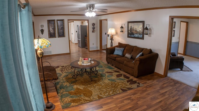 1679 Sunchase Dr, Warsaw, MO 65355 - living area featuring ornamental molding, a textured ceiling, a ceiling fan, and wood finished floors