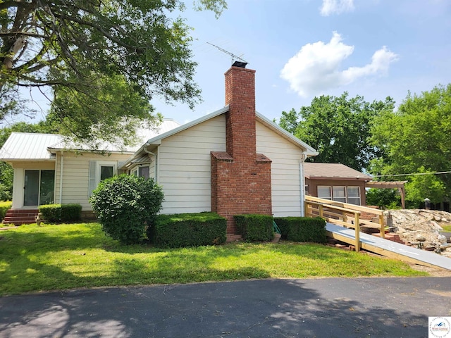 81 SE 500th Rd, Clinton, MO 64735 - view of side of property featuring a lawn and a chimney