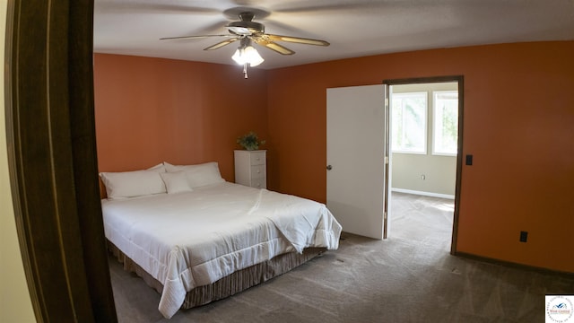carpeted bedroom featuring ceiling fan and baseboards