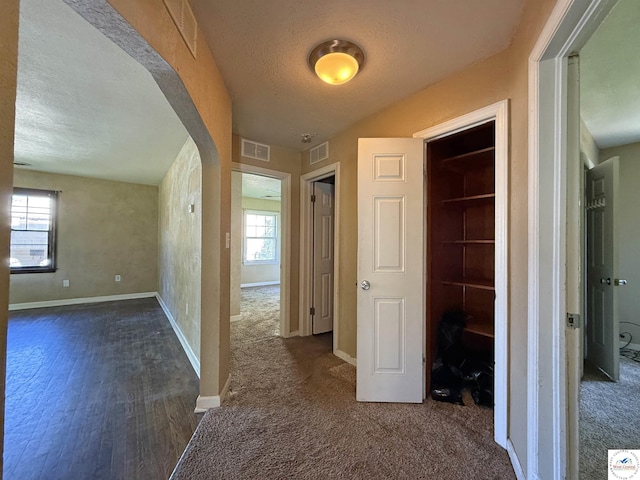 109 E Fairview St, Clinton, MO 64735 - corridor featuring a textured ceiling, dark colored carpet, and dark wood finished floors