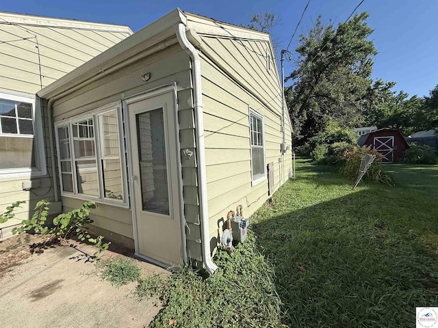 109 E Fairview St, Clinton, MO 64735 - view of side of home featuring a lawn, a patio, and a shed