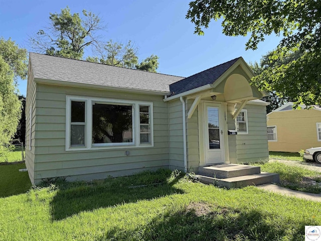 109 E Fairview St, Clinton, MO 64735 - rear view of property with a lawn and roof with shingles