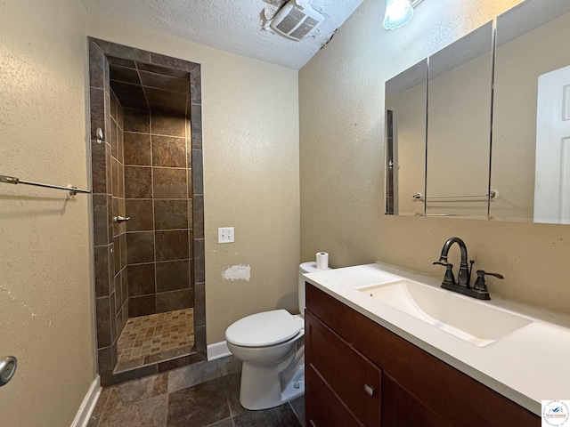 109 E Fairview St, Clinton, MO 64735 - bathroom with tiled shower, vanity, a textured wall, and a textured ceiling