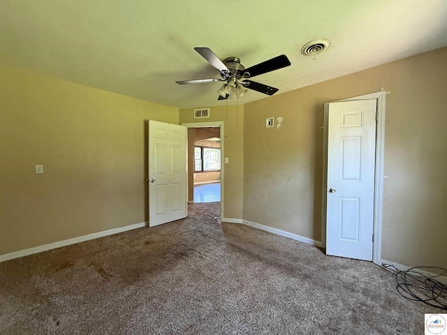 109 E Fairview St, Clinton, MO 64735 - spare room featuring a ceiling fan, carpet floors, and arched walkways
