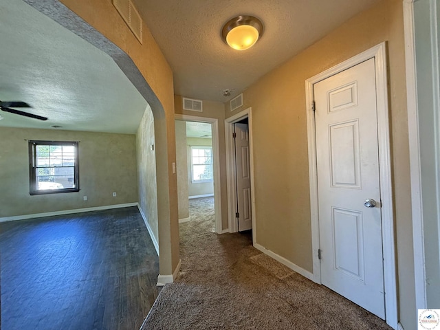 109 E Fairview St, Clinton, MO 64735 - hall featuring a textured ceiling and arched walkways