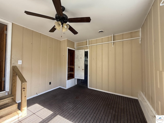 109 E Fairview St, Clinton, MO 64735 - spare room featuring ceiling fan and a decorative wall