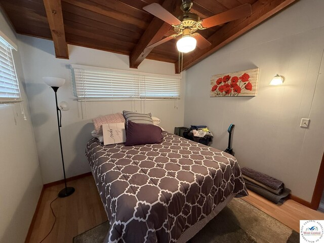 31450 Stonecrest Rd, Warsaw, MO 65355 - bedroom with wood finished floors, vaulted ceiling with beams, and multiple windows