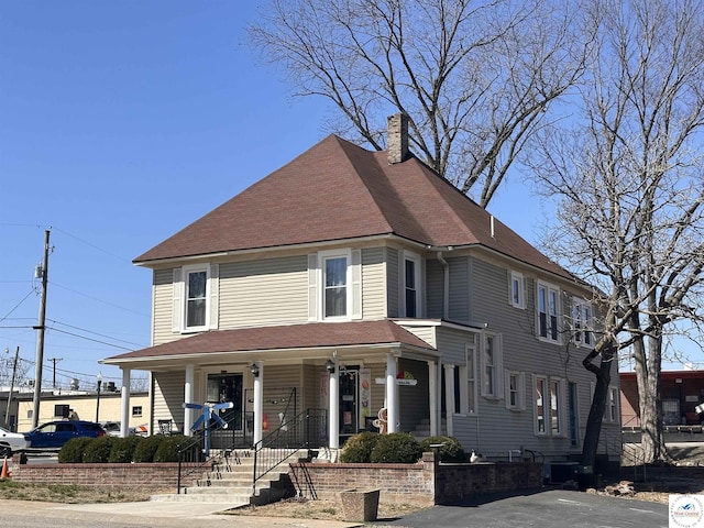 403 Van Buren St, Warsaw, MO 65355 - view of front of home featuring a chimney, a porch, and a shingled roof