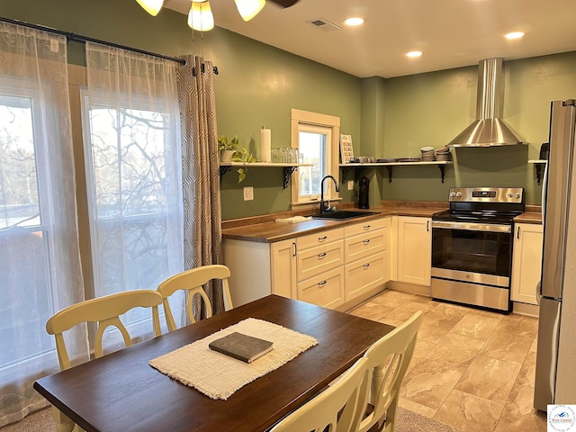 403 Van Buren St, Warsaw, MO 65355 - kitchen featuring a sink, stainless steel appliances, open shelves, wall chimney exhaust hood, and visible vents