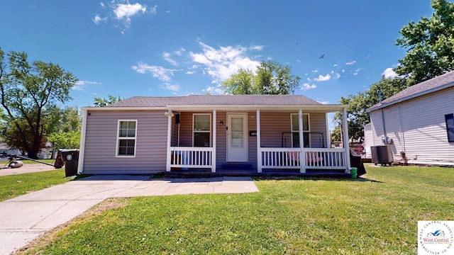 1010 E 3rd St, Sedalia, MO 65301 - view of front facade with a porch, a front yard, and central air condition unit
