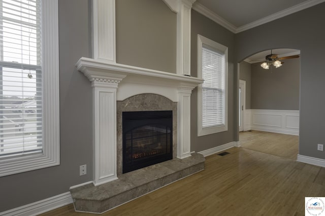 3415 Callaway Dr, Sedalia, MO 65301 - unfurnished living room featuring wood finished floors, a high end fireplace, a ceiling fan, plenty of natural light, and crown molding