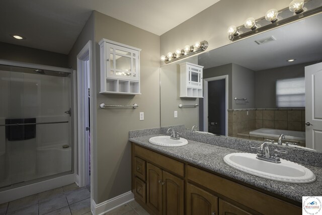 3415 Callaway Dr, Sedalia, MO 65301 - full bath featuring tile patterned flooring, a shower stall, double vanity, a bath, and baseboards